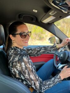 Christina-Lauren Pollack Test Driving an Alfa-Romeo at Monterey Car Week