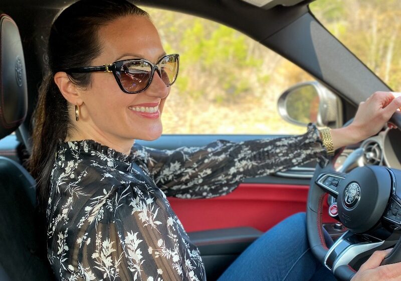 Christina-Lauren Pollack Test Driving an Alfa-Romeo at Monterey Car Week