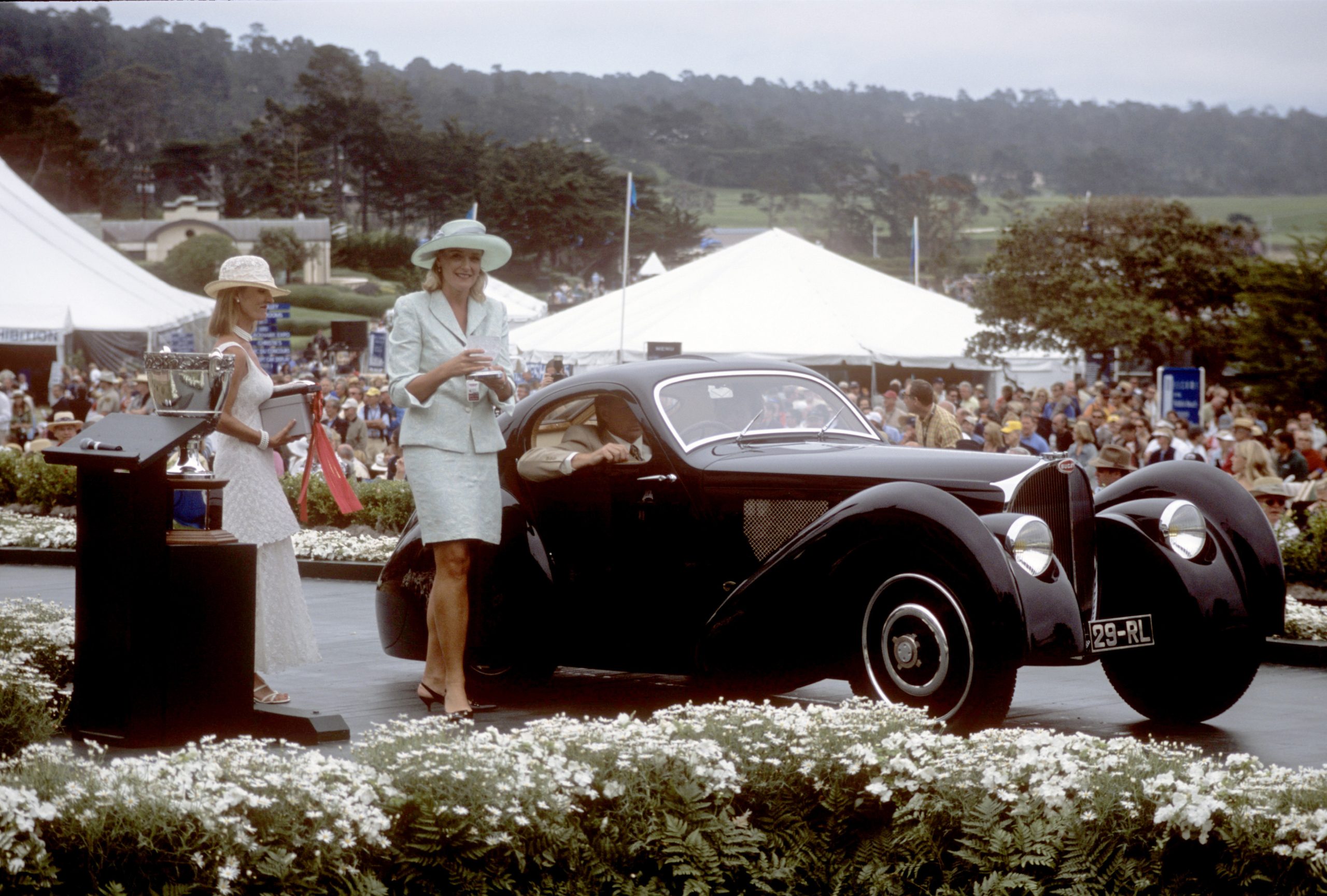 In the Driver’s Seat: How Sandra Button Steered The Pebble Beach Concours d’Elegance for 40 Years - Exhibit Year 2003 Sandra Button on Concours Ramp at The Lodge - Image credit Kimball Studios/Pebble Beach Concours d'Elegance